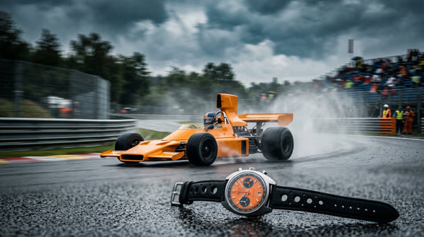 McLaren M23 1974 race car in papaya orange livery racing in the rain — the car that inspired the Cypher Paddock 74 chronograph